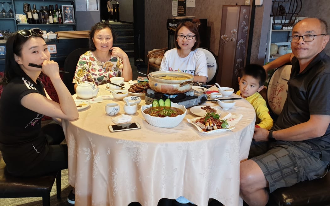 Trey Fan, left, having dinner with friends at the Meet Creative Chinese Restaurant on Dominion Road. Chinese New Year's Eve