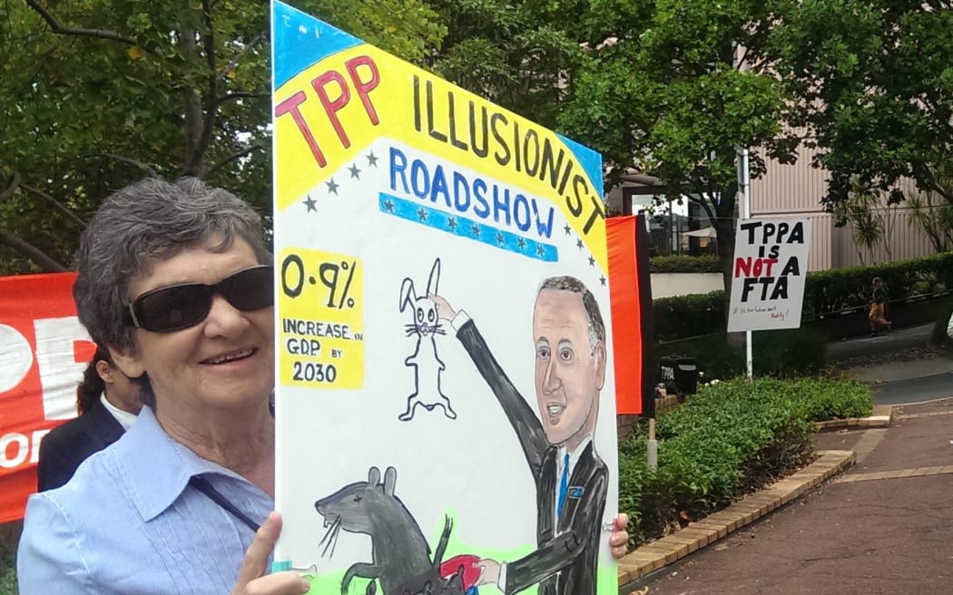 A protestor outside a seminar being held as part of the government's TPP roadshow.