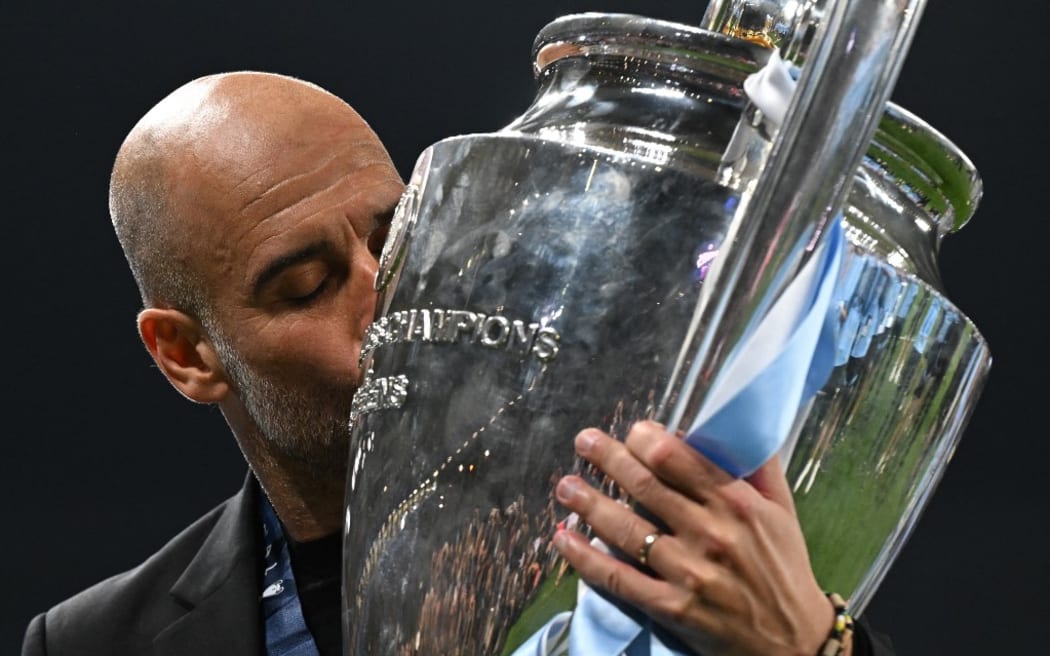 Manchester City's Spanish manager Pep Guardiola kisses the European Cup trophy as they celebrate winning the UEFA Champions League final football match between Inter Milan and Manchester City at the Ataturk Olympic Stadium in Istanbul, on June 10, 2023. Manchester City won the match 1-0. (Photo by Paul ELLIS / AFP)