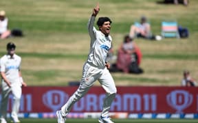 New Zealand spin bowler Rachin Ravindra celebrates dismissing South Africa's Keegan Petersen.