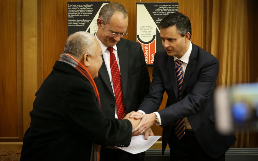Reverend Iosefa Suamalie (left), Phil Twyford (middle) and James Shaw (right) shaking hands after the climate change petition was passed over today.