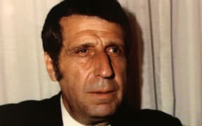 headshot of composer Arno Babajanian in suit and tie