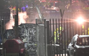 Emergency services work at the scene on the wreckage of a helicopter that crashed in a car park outside Leicester City Football Club's King Power Stadium in Leicester, England.