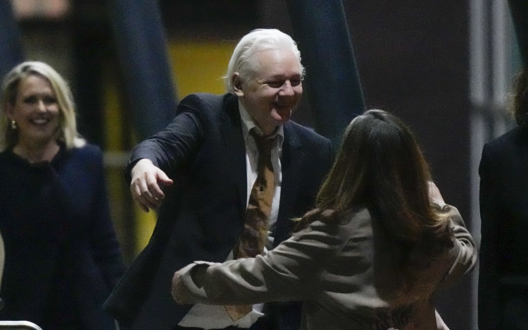 WikiLeaks founder Julian Assange embraces his wife Stella after landing in Canberra, Australia, on 26 June 2024.