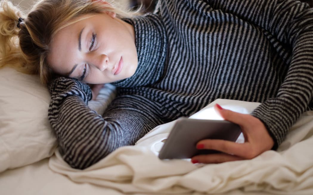 89247445 - teenage girl victim of bullying reading text message