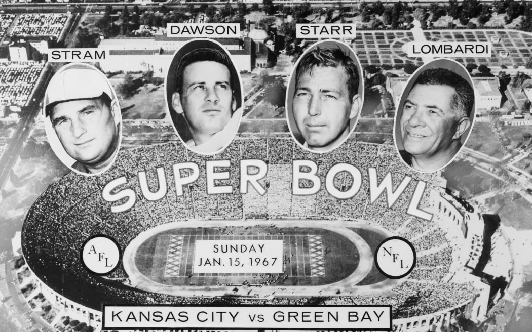 The stage is set at Los Angeles Memorial Coliseum for the Super Bowl, starring quarterbacks Len Dawson, of the American Football League's Kansas City Chiefs, and Bart Starr, of the National Football League's Green Bay Packers. In prominent supporting roles are Chiefs' coach Hank Stram and Packers' coach Vince Lombardi.