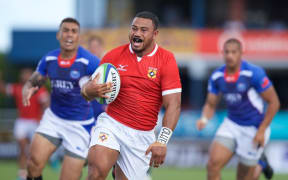 Tonga's Penikolo Latu races away to score Tonga's third try.