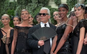 Karl Lagerfeld with Canadian model Linda Evangelista, left, and British model Naomi Campbell, right, and other models after the presentation of his 1996-97 fall-winter haute couture fashion collection for Chanel in Paris.
