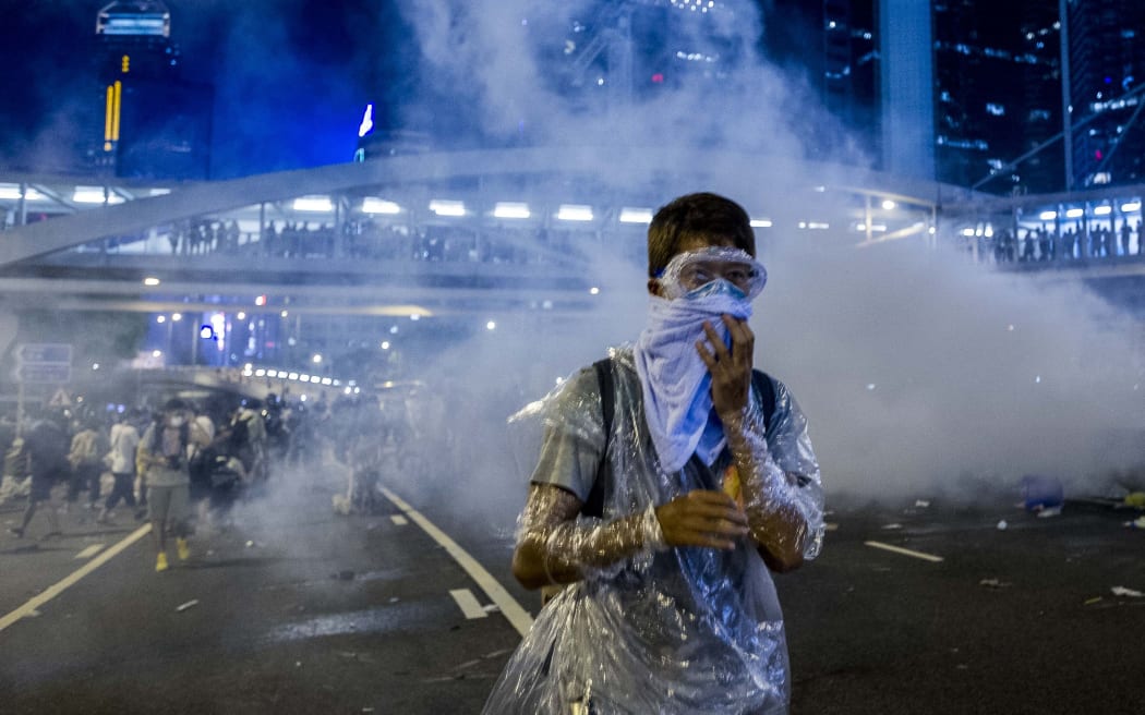 Protesters used umbrellas and face masks to defend themselves tear gas.