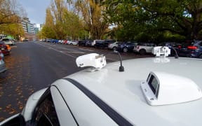 Auckland Transport's new camera cars can digitally chalk a car parked too long. This one is checking the licence plates of cars parked in Princes St.