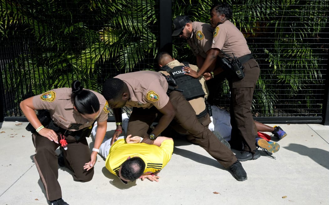 Security personnel detain a Colombia supporter who that tried to get into the Hard Rock Stadium in Miami without tickets ahead of the Conmebol 2024 Copa America tournament final football match between Argentina and Colombia.