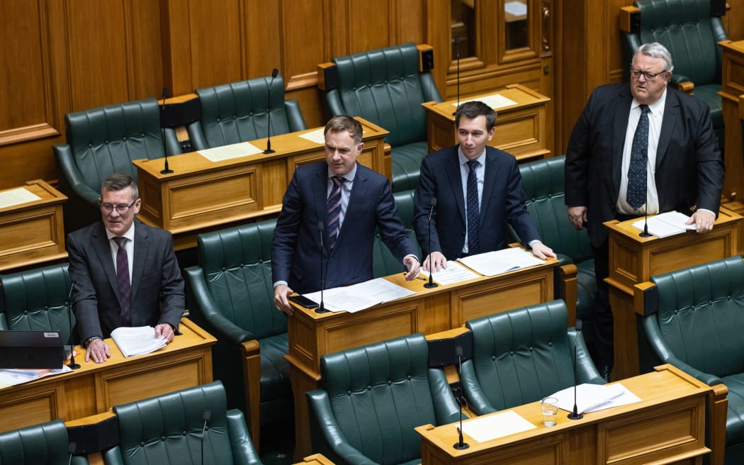 National MPs (from left) Michael Woodhouse, Simon Watts, Simeon Brown, and Gerry Brownlee rise together calling for the next speech during the committee stage of Rachel Boyack's Plain Language Bill.