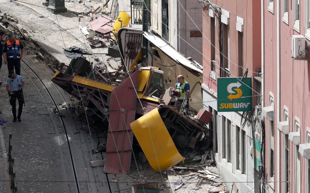 Police and civil protection members work on the site of the Gloria funicular accident that killed 16 in Lisbon, on September 4, 2025. The accident of a funicular on September 3, 2025 caused 16 dead and 5 seriously injured in Lisbon, rescuers announced. (Photo by PATRICIA DE MELO MOREIRA / AFP)