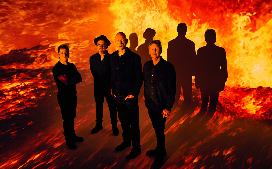 Midnight Oil the band standing in front of flames