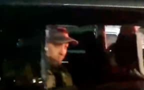 This video grab taken from handout footage posted late on 24 June, 2023 on the Telegram channel @rstv01 shows Yevgeny Prigozhin looking on from a car as he leaves the headquarters of the Russian southern military district in the city of Rostov-on-Don.