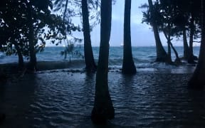 High tide driven by storm waves washes into Ejit Island in Majuro Atoll, flooding a significant part of the small island that is home to displaced Bikini Islanders.