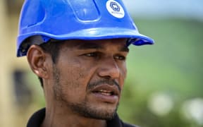 Miguel Baez, a volunteer rescuer, stands outside the collapsed apartment building where his family lived as he and relatives search for family members believed to be trapped inside, in Caraballeda, La Guaira state, Venezuela, on July 12, 2026. The twin earthquakes that struck Venezuela on June 24 had left nearly 4,500 people dead as of July 12, while much of the affected population continued to live in camps, according to official figures. (Photo by MARTIN BERNETTI / AFP)