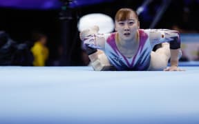 (FILES) Japan's Shoko Miyata falls as she competes in the Women's Team Final during the 52nd FIG Artistic Gymnastics World Championships, in Antwerp, northern Belgium, on October 4, 2023. Japanese gymnast Shoko Miyata has been sent home from the Paris Olympics over allegations of smoking, local media reported on July 19. (Photo by KENZO TRIBOUILLARD / AFP)