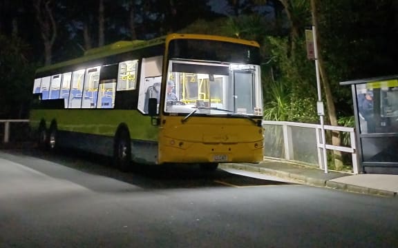 Metlink bus and bus stop after dark.