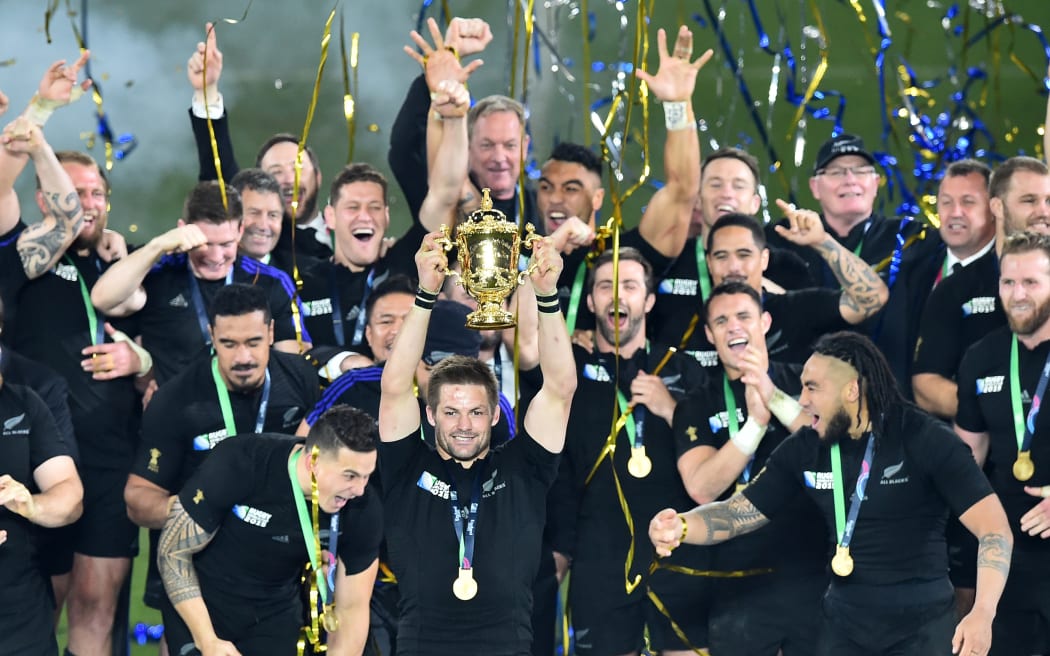 Richie McCaw holds the Webb Ellis Cup as the All Blacks become world champions for a record third time.