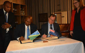 The Solomon Islands Minister of Foreign Affairs and External Trade, Milner Tozaka signs a revised Joint Commitment for Development with his New Zealand counterpart, Murray McCully, in Wellington.