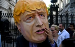 A man wearing a mask of Boris Johnson protests outside Downing Street, after news Parliament will be suspended just days after MPs return to work in September  - and just a few weeks before Brexit.