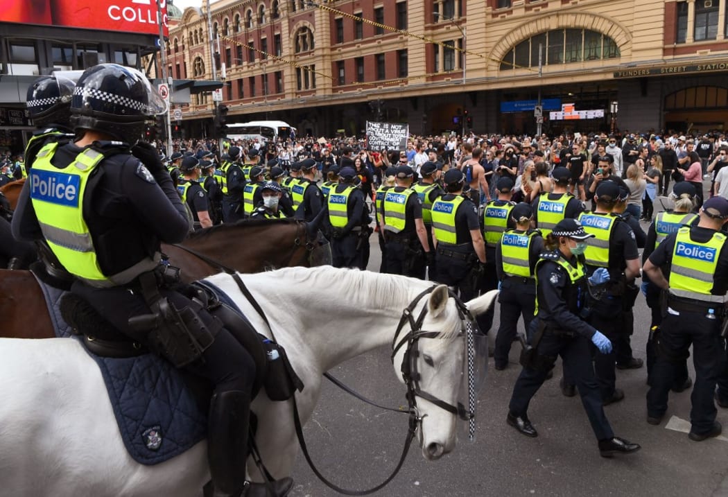 Police face off with protesters in Melbourne.