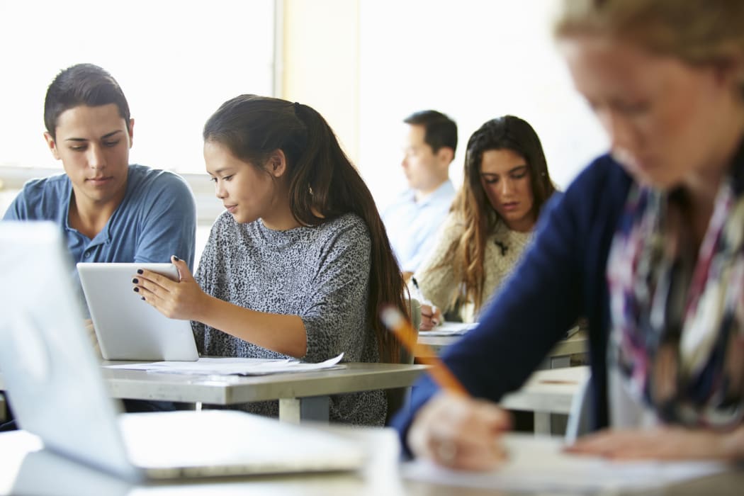 High school students with laptops and digital tablets