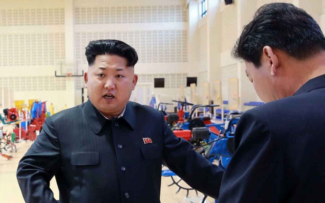 North Korean leader Kim Jong-Un visiting a farm machine exhibition.