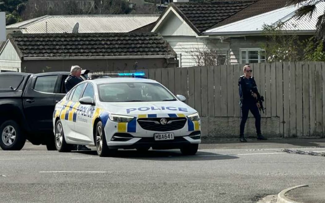 Armed police on the corner of Motueka St and Vanguard St in Nelson.