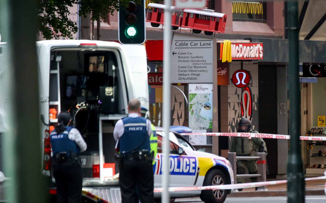 A police bomb squad member can be seen bottom right walking into McDonald's after a suspicious bag was blown up.