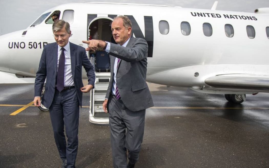 The United Nations (UN) Under-Secretary-General for Peacekeeping Operations, Jean-Pierre Lacroix (L), walks out from a UN plane accompanied by the Head of the UN Mission in South Sudan (UNMISS), David Shearer, after landing in Juba, South Sudan, on August 1, 2017.