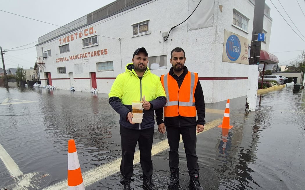 Dunedin locals delivering hot meals to flood-affected residents.