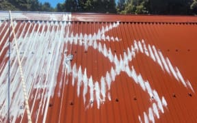 Swastika tagging on the Kirwans Hut roof which required several coats of paint to cover up.