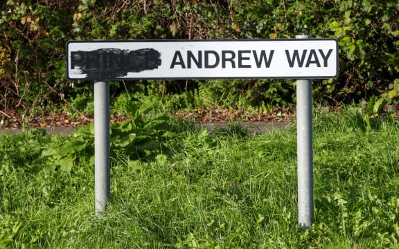 This general view shows a sign for a street originally named after Britain's former prince Andrew, with the title of "prince" blackened out, along a road in the town of Carrickfergus, County Antrim in Northern Ireland on November 25, 2025. A Northern Irish council has voted to rename a street in the town of Carrickfergus called after Britain's disgraced former Prince Andrew after now known as Andrew Mountbatten Windsor. (Photo by Paul Faith / AFP)