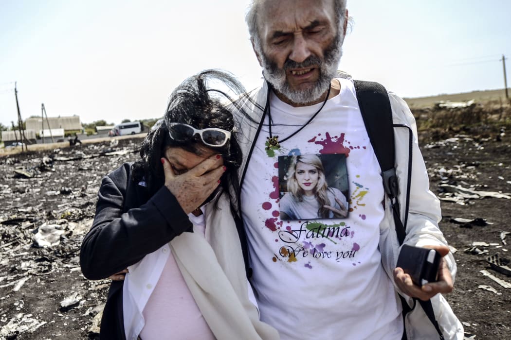 Jerzy Dyczynsk (R) and Angela Rudhart-Dyczynski from Australia show grief as they arrive at the crash site to look for their late daughter, Fatima.