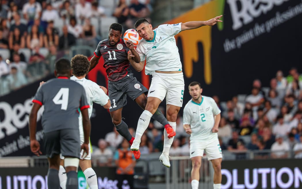 New Zealand's Michael Boxall New Caledonia's César Zeoula.