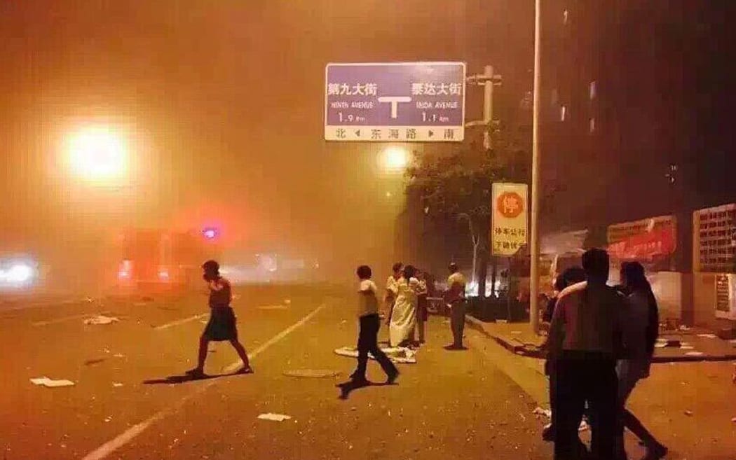 A mobile phone picture shows people taking shelter the huge explosion in Tianjin.