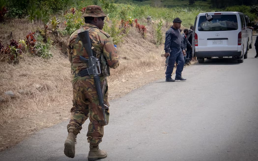 PNG soldiers carry automatic weapons similar to the ones wielded by tribal warlords.