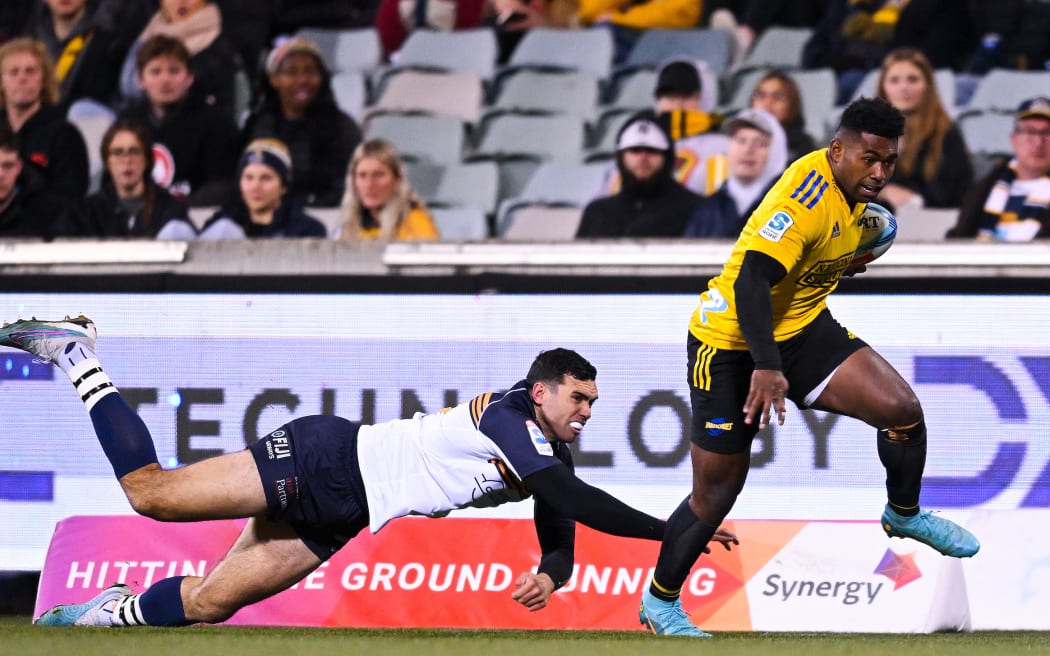 Kini Naholo of the Hurricanes on his way to scoring a try in the Super Rugby Pacific quarterfinal against the Brumbies in Canberra - 10/6/2023