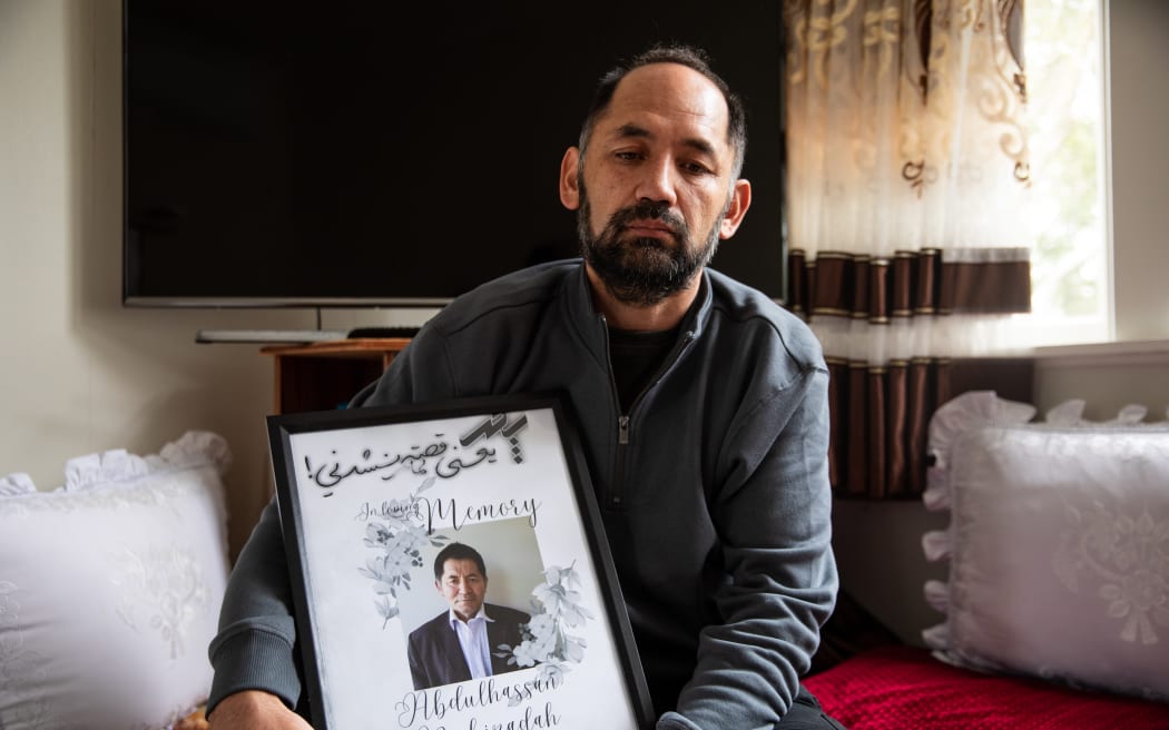 John Nabizadah with a picture of his father