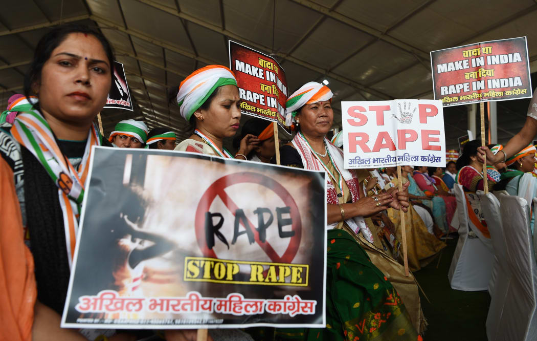 Supporters of President of the Indian National Congress Party Rahul Gandhi hold placards in reaction to the recent rape cases in India during a rally dubbed Jan Aakrosh Rally (public outrage), in New Delhi