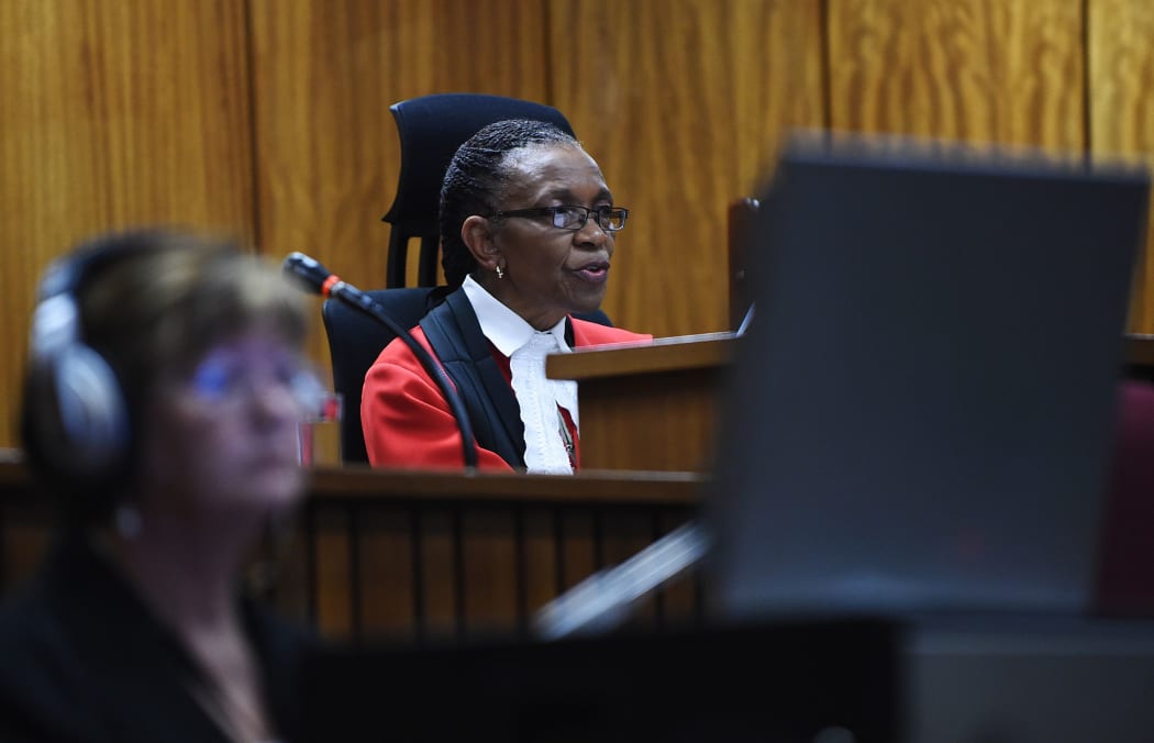 Judge Thokozile Masipa hands down her verdict on September 11, 2014 at the High Court in Pretoria on whether South African paralympian athlete Oscar Pistorius is guilty of the 2013 Valentine's Day murder of his model girlfriend.