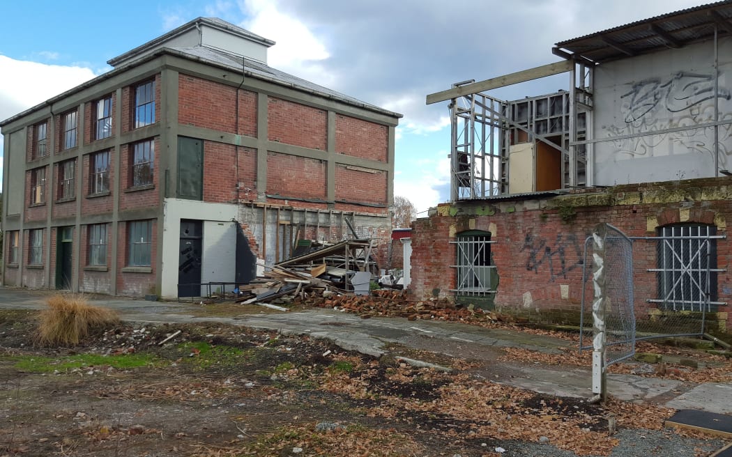 Two brick, two storey buildings. One severely damaged.