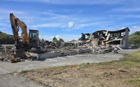 The school block destroyed in a suspected arson is being demolished.