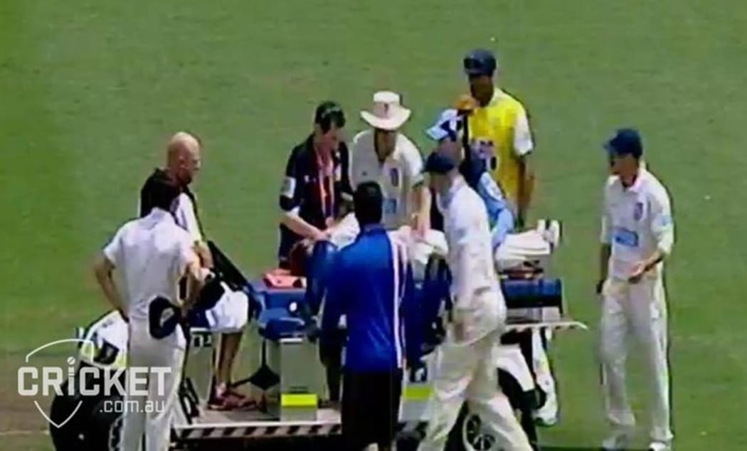 Phil Hughes being taken from the Sydney Cricket Ground on a stretcher.