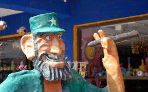 A statue of Fidel Castro holding a cigar outside a Cuban cigar store. Bringing cigars and rum from Cuba to the United States is now allowed.