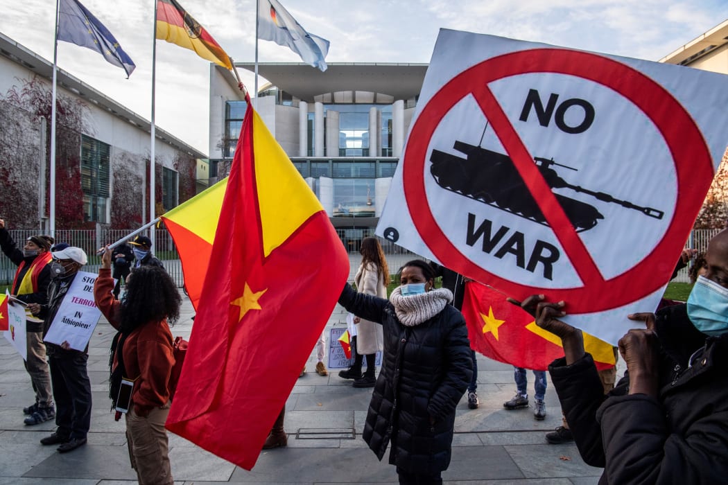 Pro-Tigrayan demonstrators display placards during a protest in front of the Chancellery in Berlin on November 12, 2020.