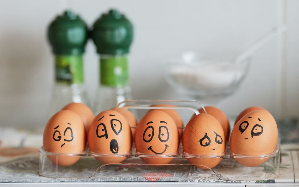 A row of eggs with drawn-on expressions of different emotions.