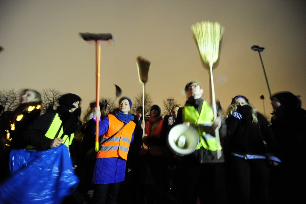 Demonstrators with brooms protest against a rally by a mounting right-wing populist movement - Pegida - on January 5, 2015 in Dresden, Germany.